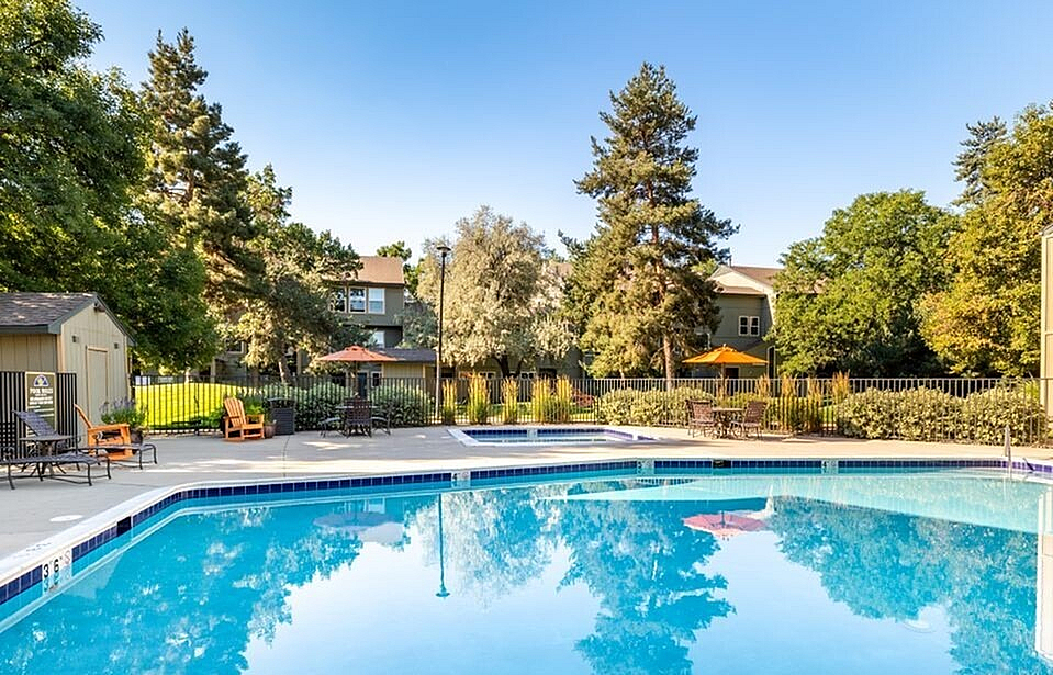 Inviting outdoor swimming pool surrounded by lush greenery and comfortable seating, perfect for relaxation and leisure.