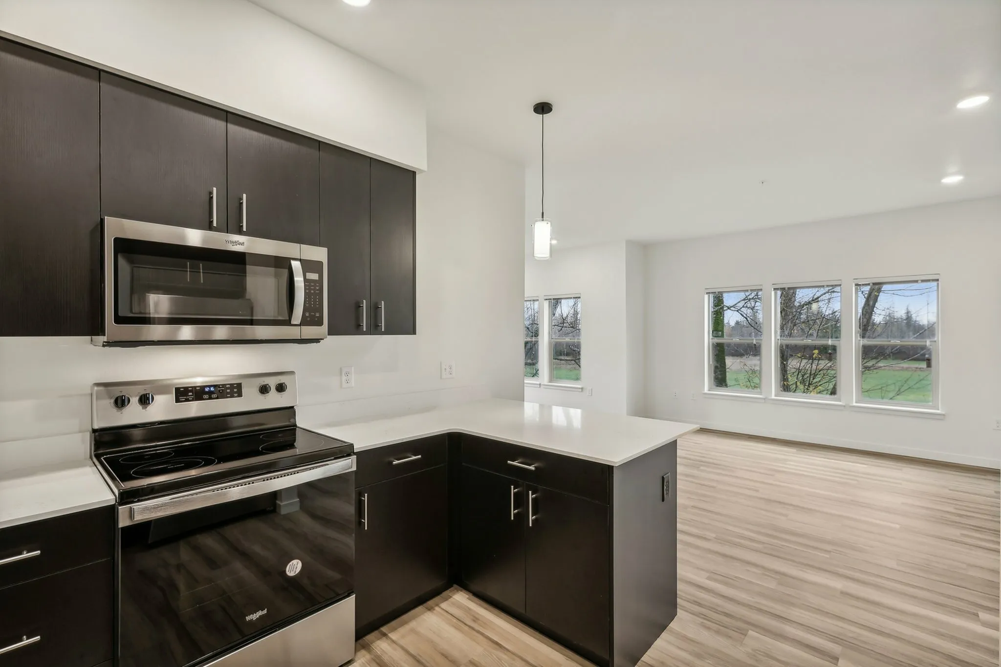 The large kitchen features a peninsula for counter height bar stools.