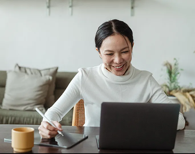 Cheerful person working on marketing projects in a cozy living room space, featuring a comfortable sofa and a stylish workspace setup.