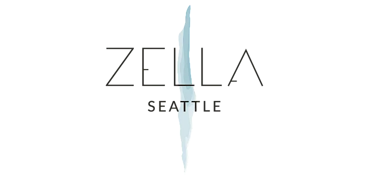 Zella Seattle logo in white with a vertical watercolor blue shape on a transparent background