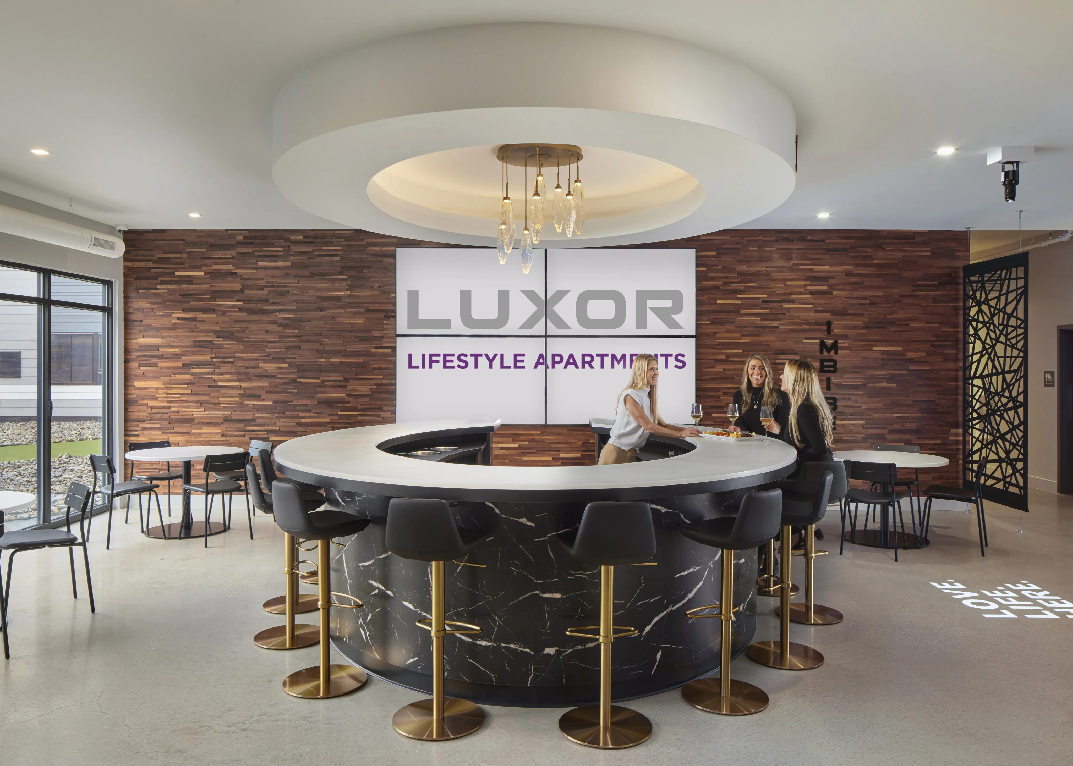 Stylish lounge with a circular bar, black stools, and