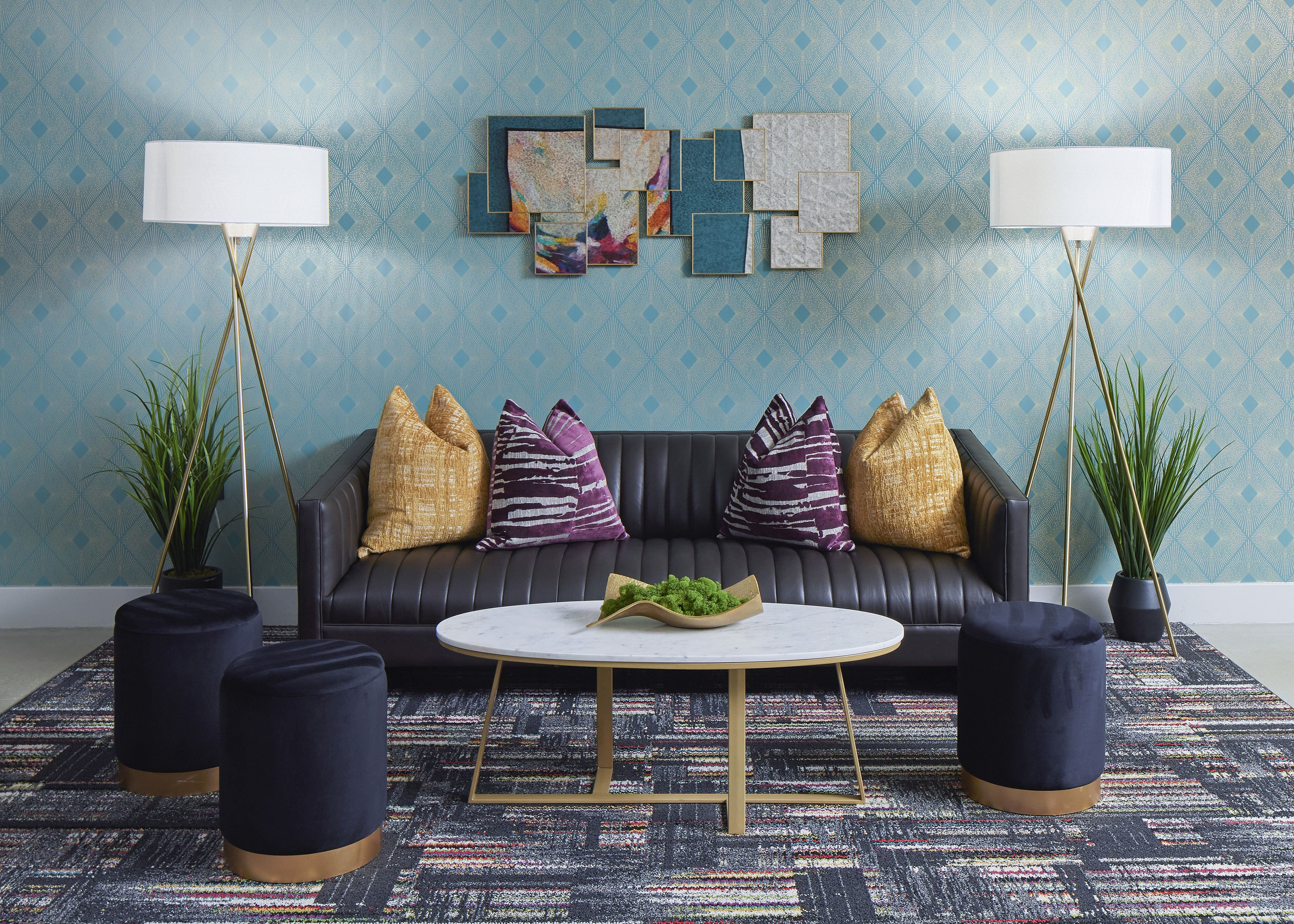 Chic living room with plush black sofa, vibrant pillows, modern art, and elegant decor.