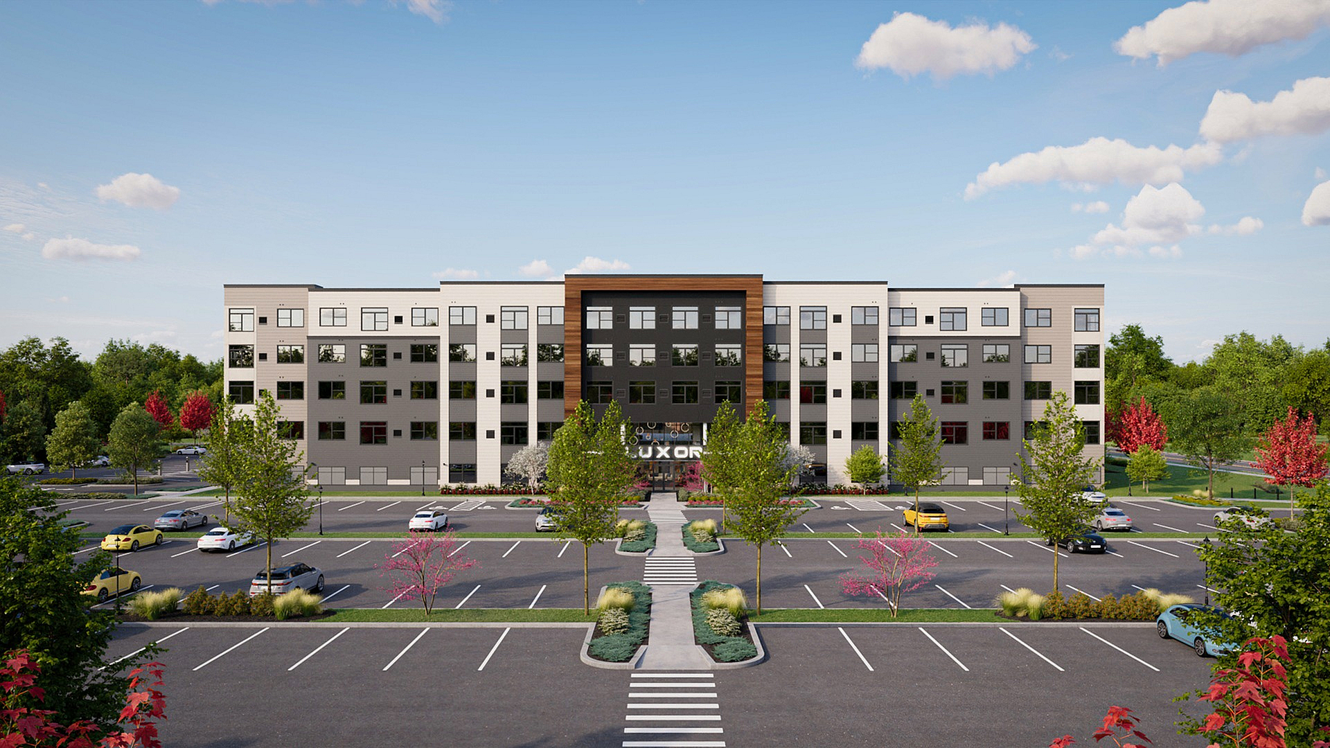 Modern apartment complex exterior with ample parking, lush greenery, and an inviting entrance under a bright blue sky.