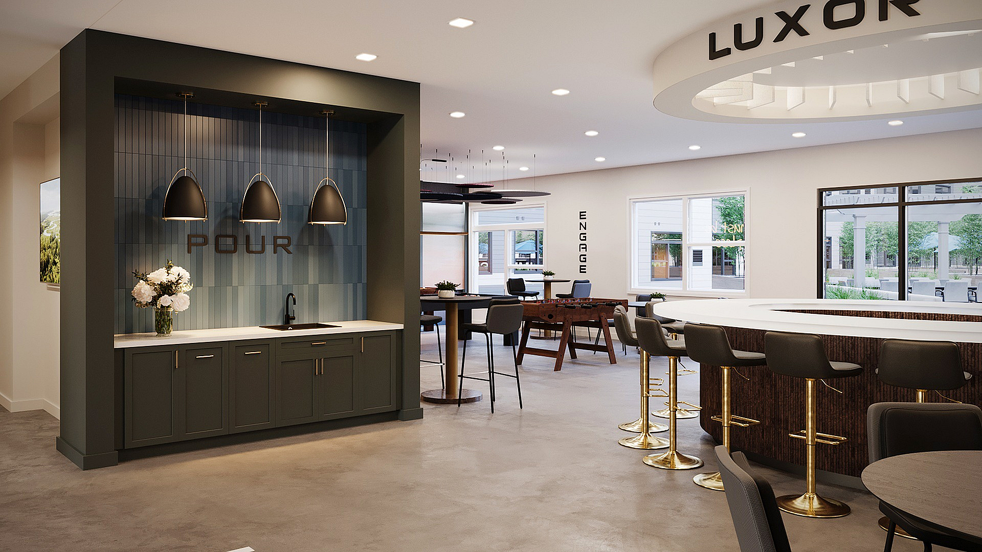 Modern communal space with a sleek bar area, elegant pendant lighting, and natural light pouring in through large windows.