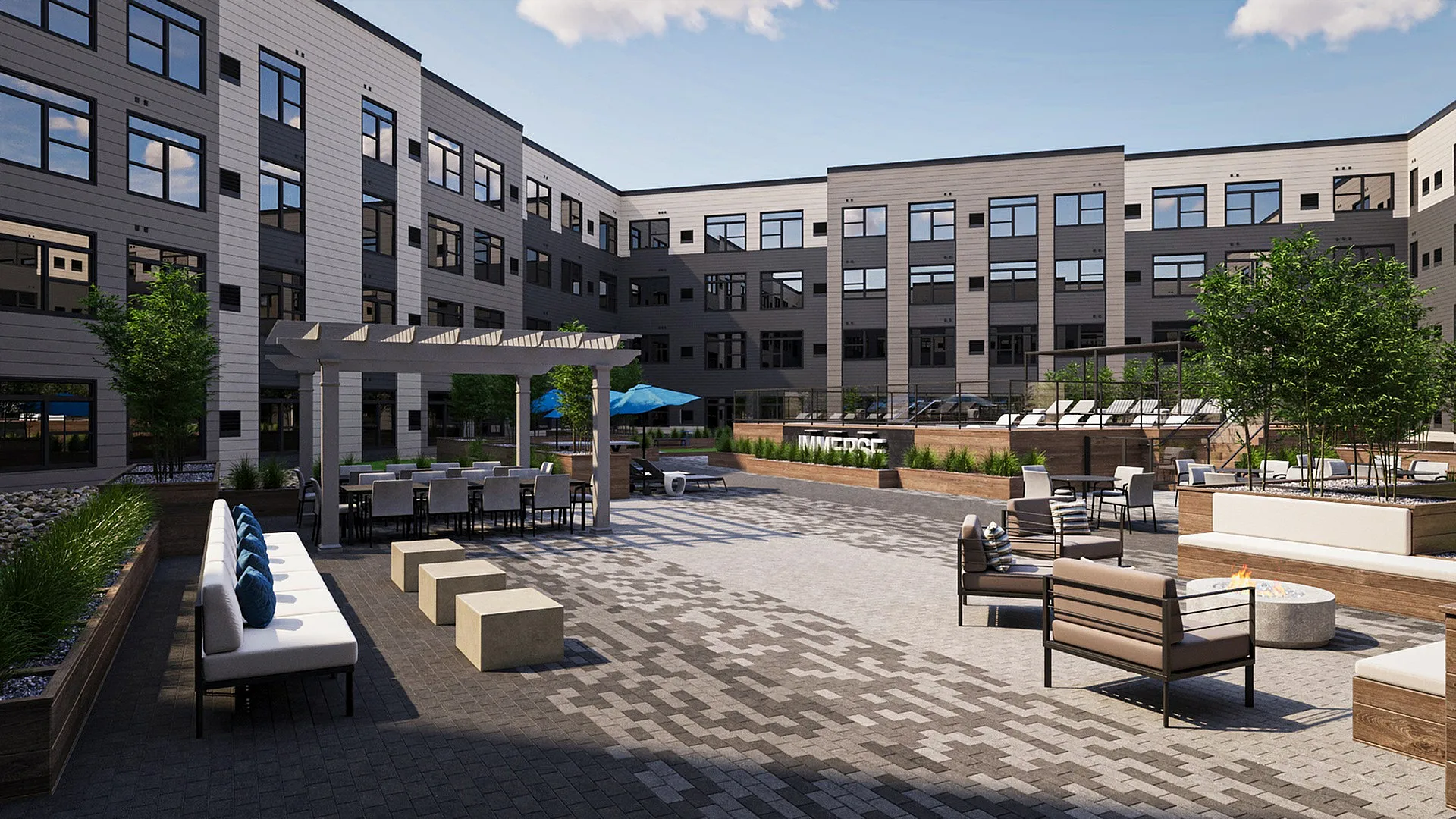 Modern apartment complex with a beautifully landscaped courtyard featuring lush greenery, stylish seating areas, and a cozy fire pit for relaxation.