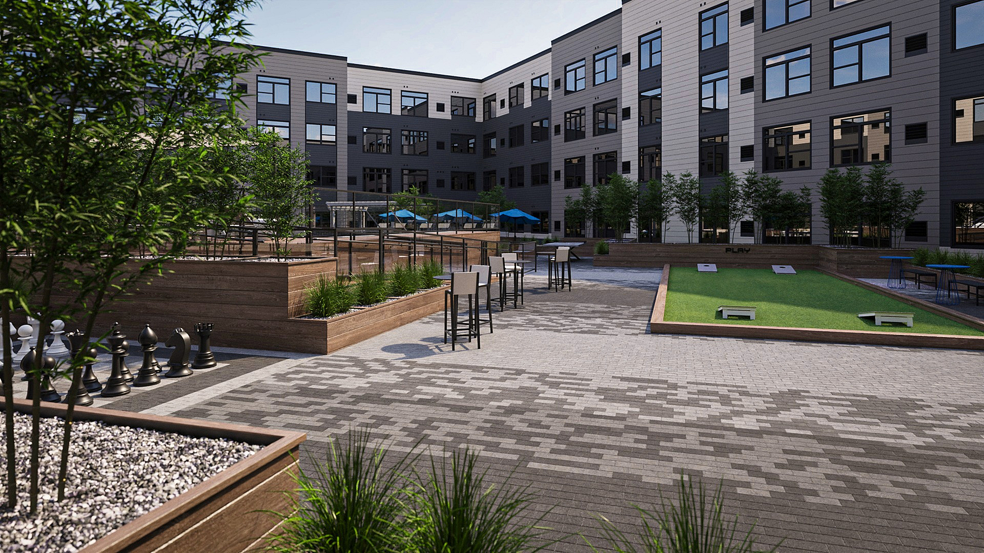 Inviting outdoor communal space featuring lush greenery, stylish seating, a large chess set, and a bocce court for leisure and relaxation.