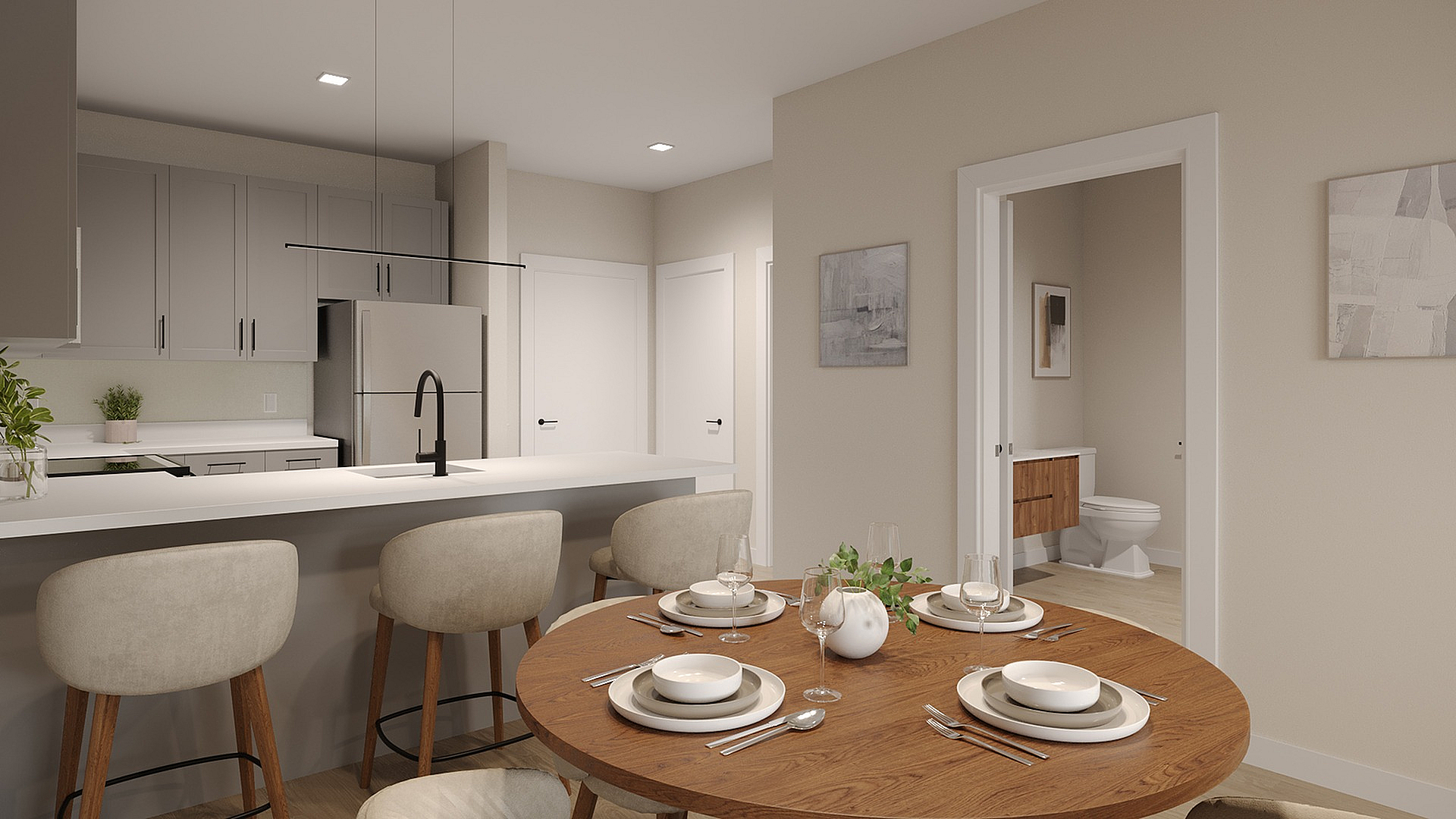 Modern kitchen and dining area with chic bar stools, elegant table setting, and a glimpse of a contemporary bathroom through the door.