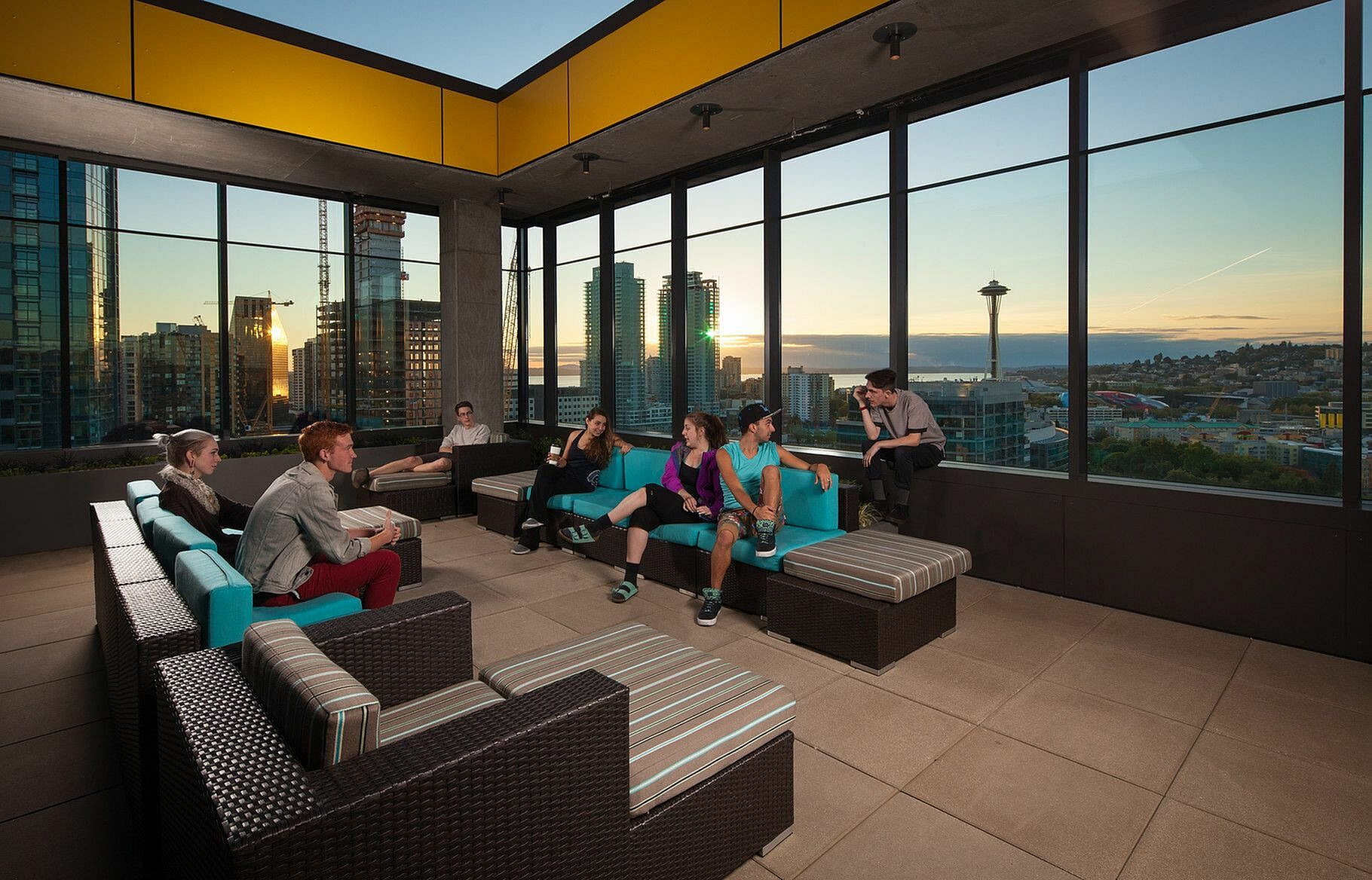Vibrant rooftop lounge offering panoramic city views and modern seating, perfect for social gatherings.