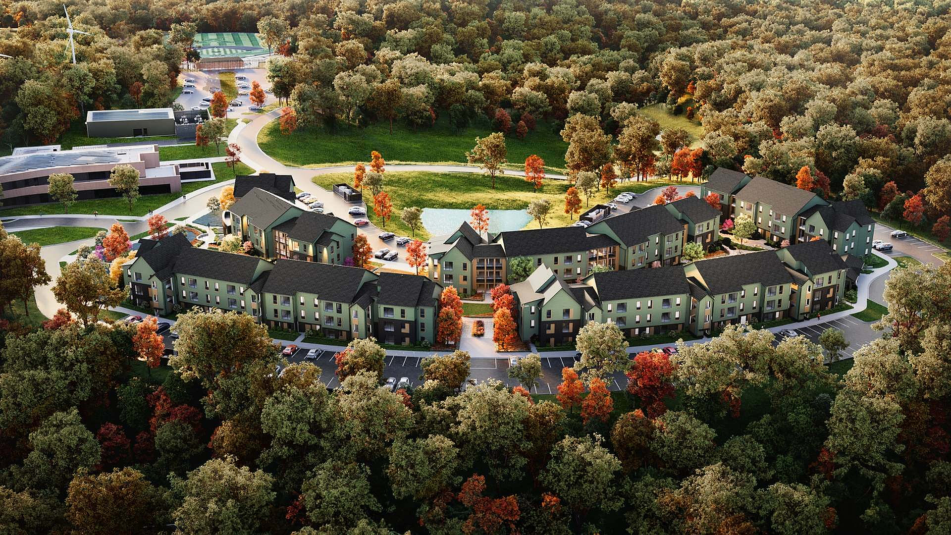 Aerial view of elegant apartment complex surrounded by lush greenery and vibrant autumn foliage, featuring modern architecture and ample parking.