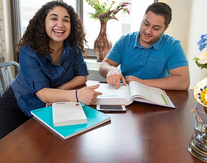 Bright and inviting study space showcasing a cozy atmosphere with smiling individuals, colorful decor, and ample natural light.
