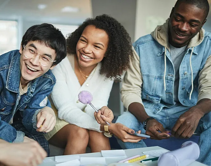 Vibrant group of friends enjoying a joyful conversation in a modern apartment setting.