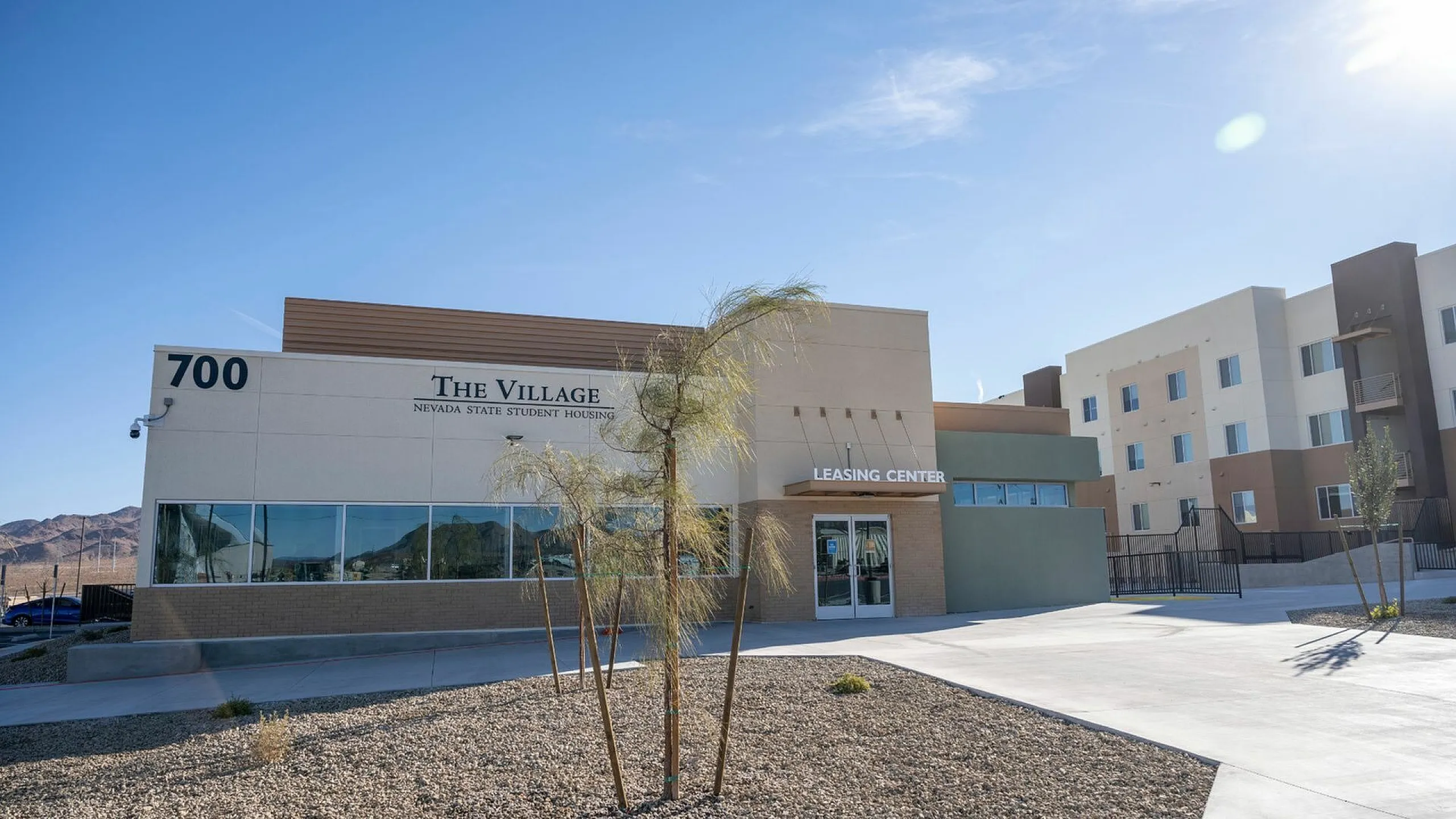 Charming student housing at The Village featuring modern architecture, clear skies, and mountain views.