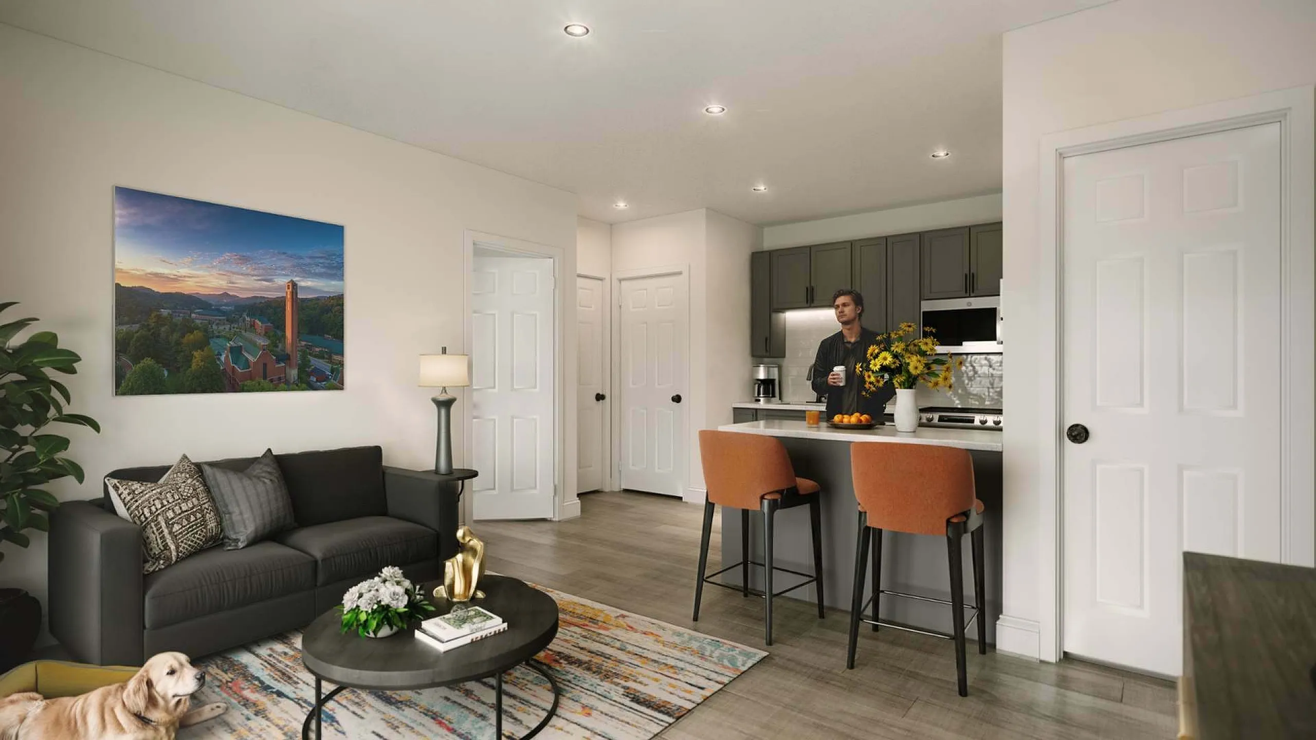 Modern apartment living area with sleek design; features a cozy sofa, vibrant artwork, and a stylish kitchen island with bar stools.