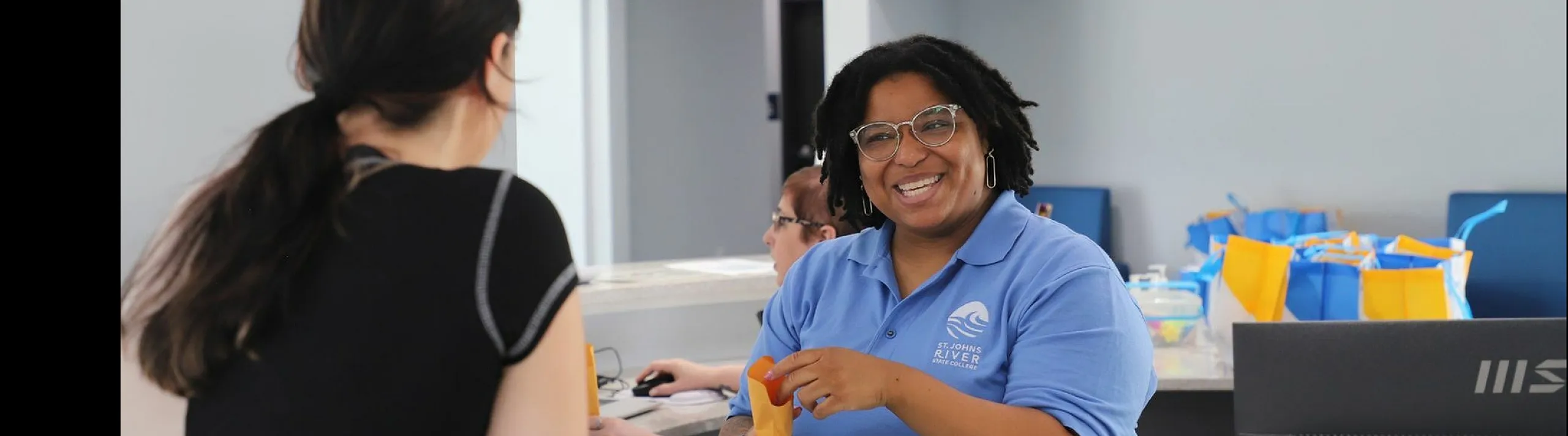 Welcoming reception area with friendly staff member offering assistance, enhancing the inviting atmosphere.