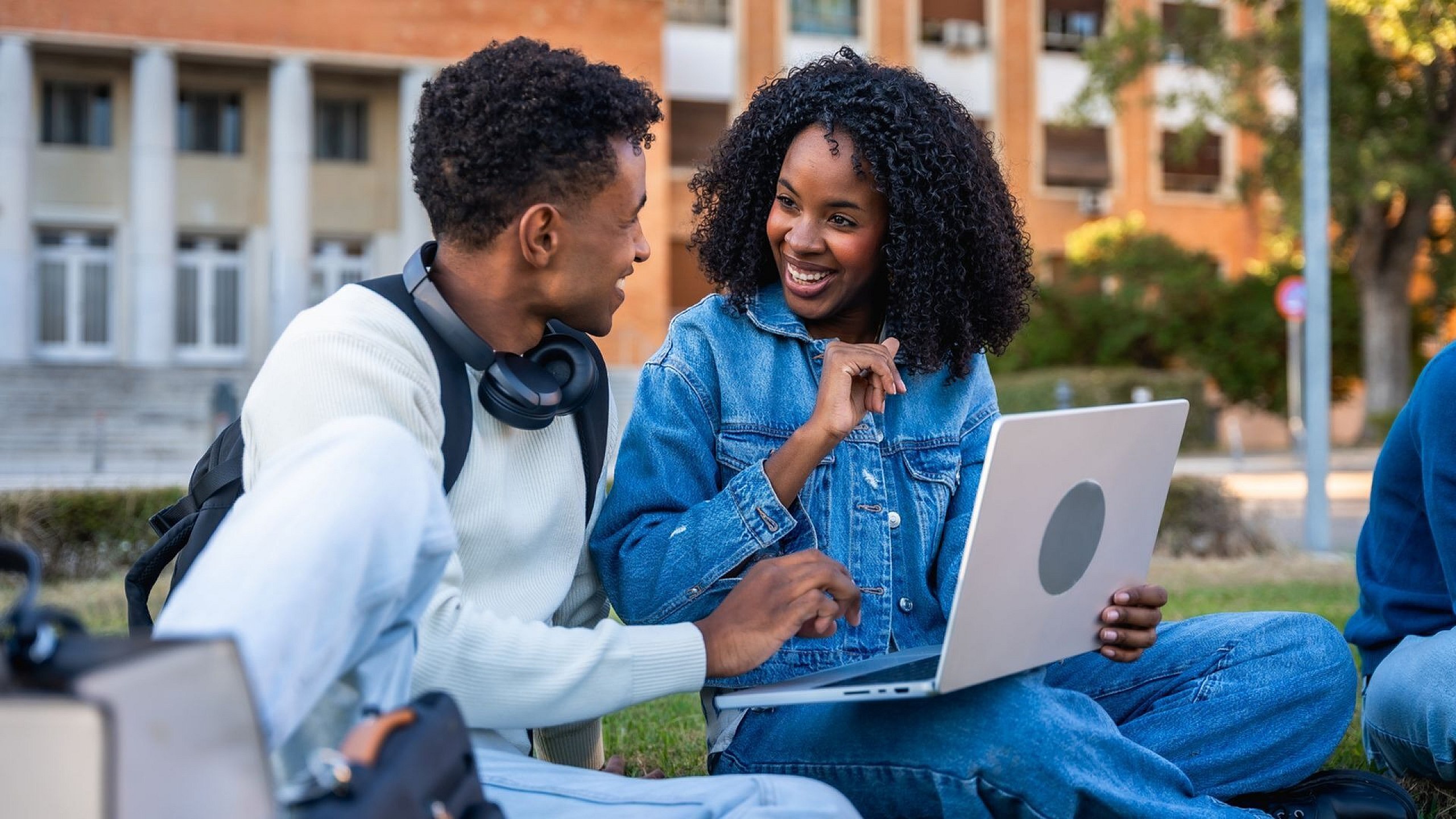 two students outside smiling