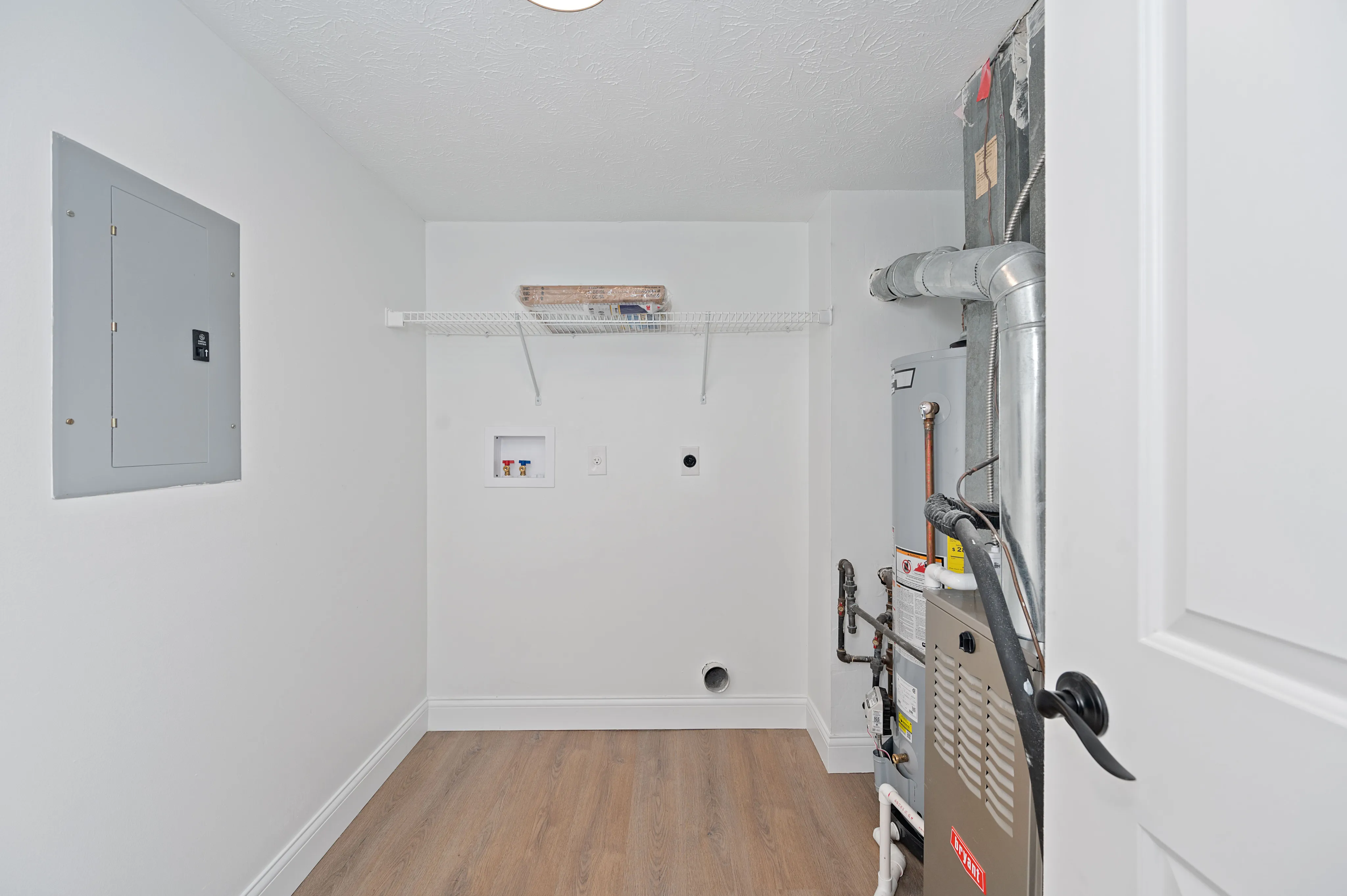 Airy utility room featuring modern HVAC system and sleek white walls.