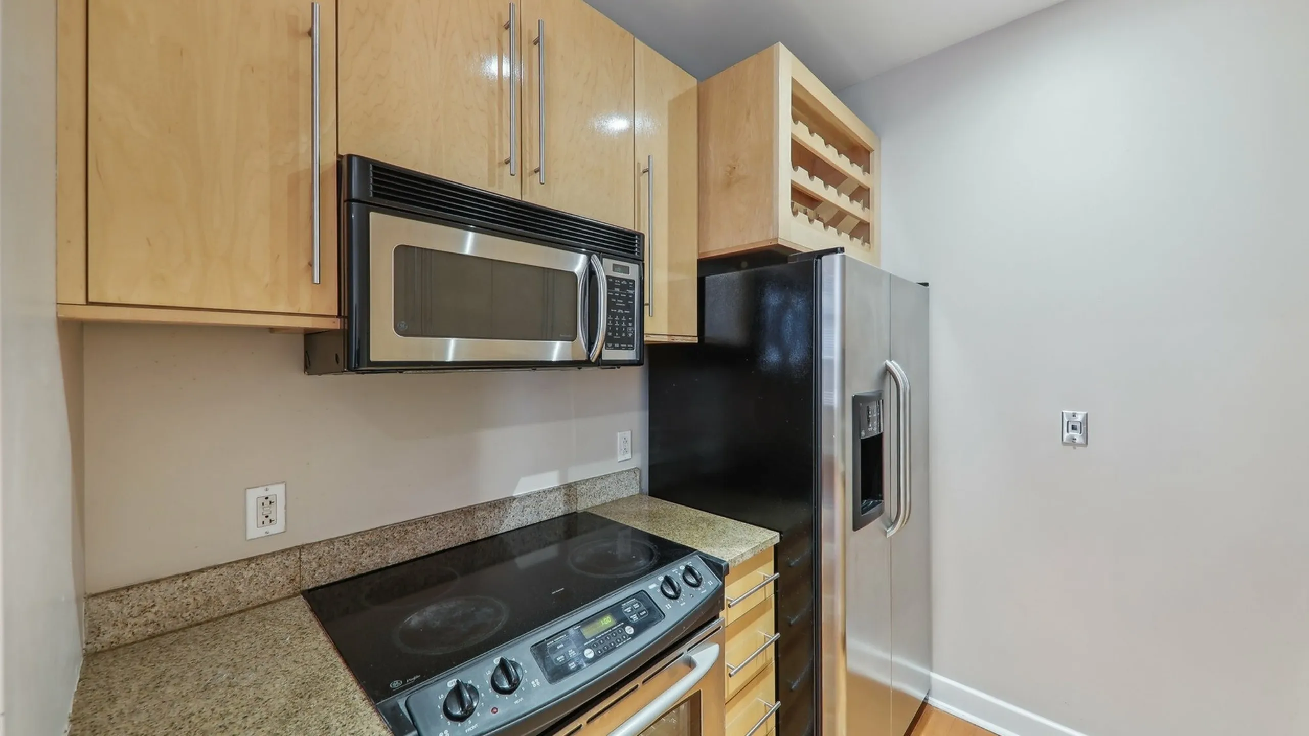 European kitchen cabinetry, with wine rack and double sided fridge