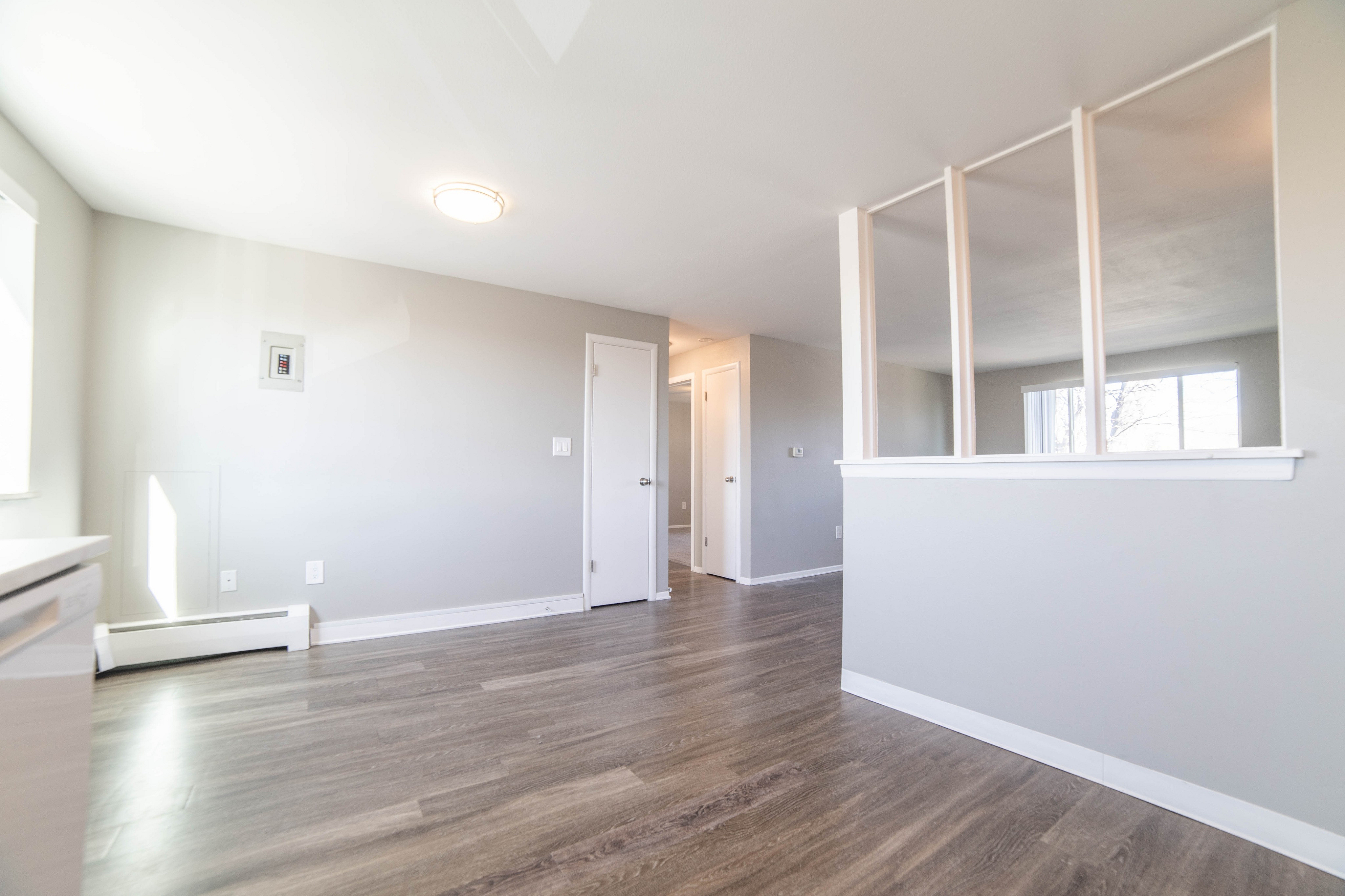 Bright and modern open-plan living area with sleek hardwood floors and ample natural light.