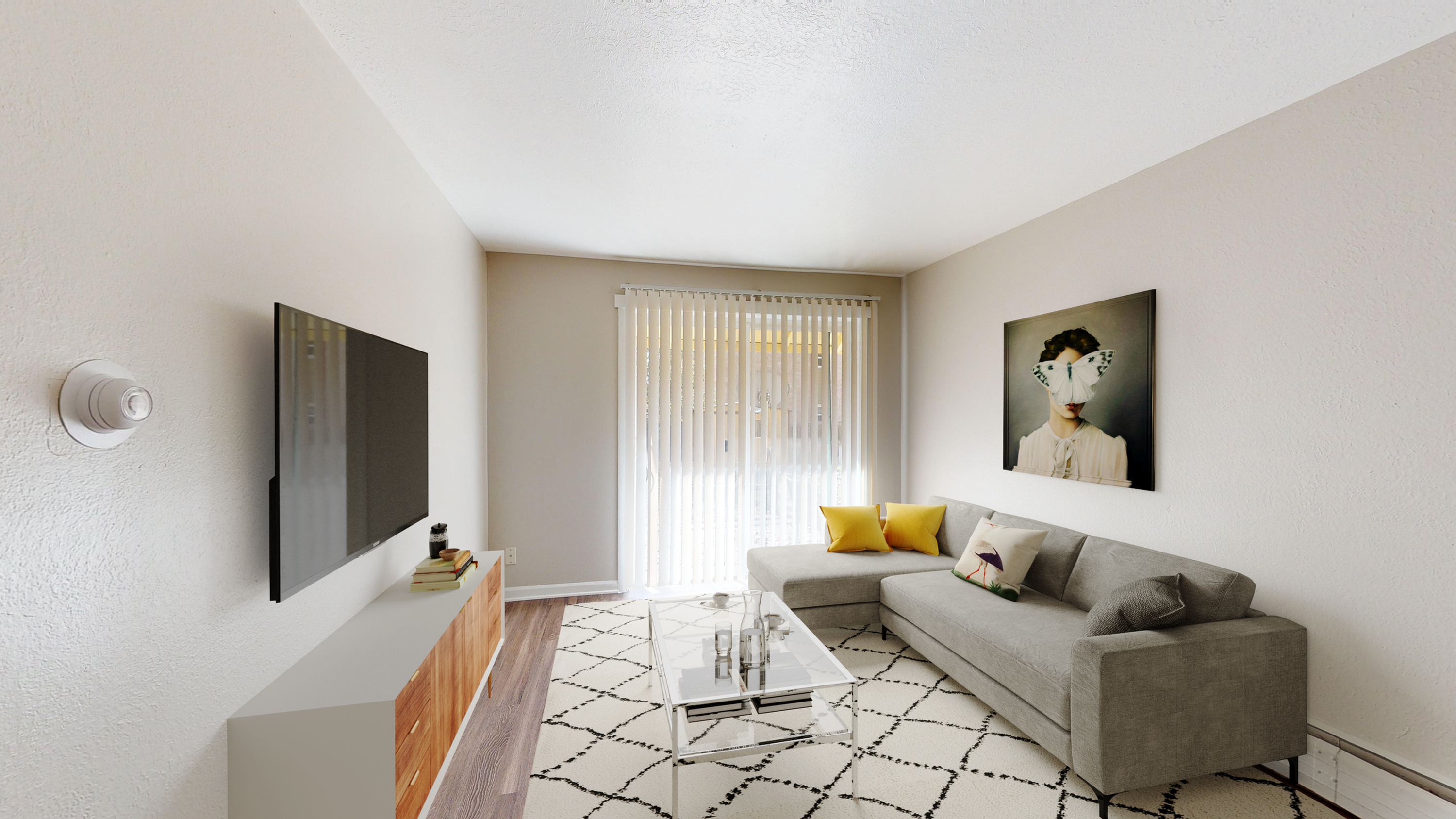 Chic living room with contemporary decor, featuring a plush gray sofa, vibrant yellow accents, and a stylish wall art centerpiece.