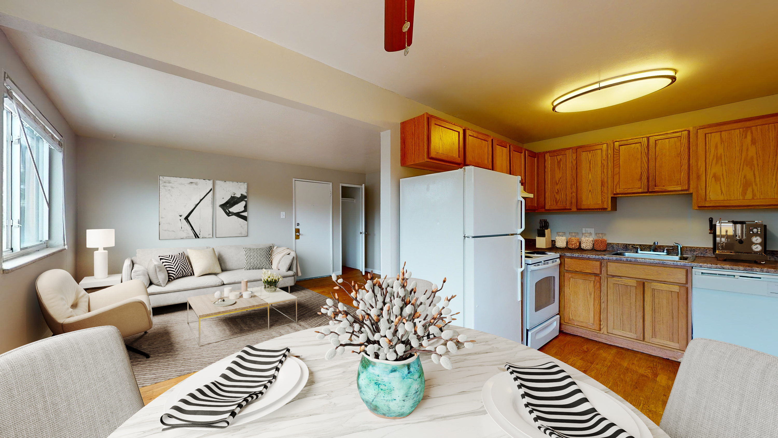 Inviting open-concept living area with modern kitchen, cozy seating, and stylish decor.