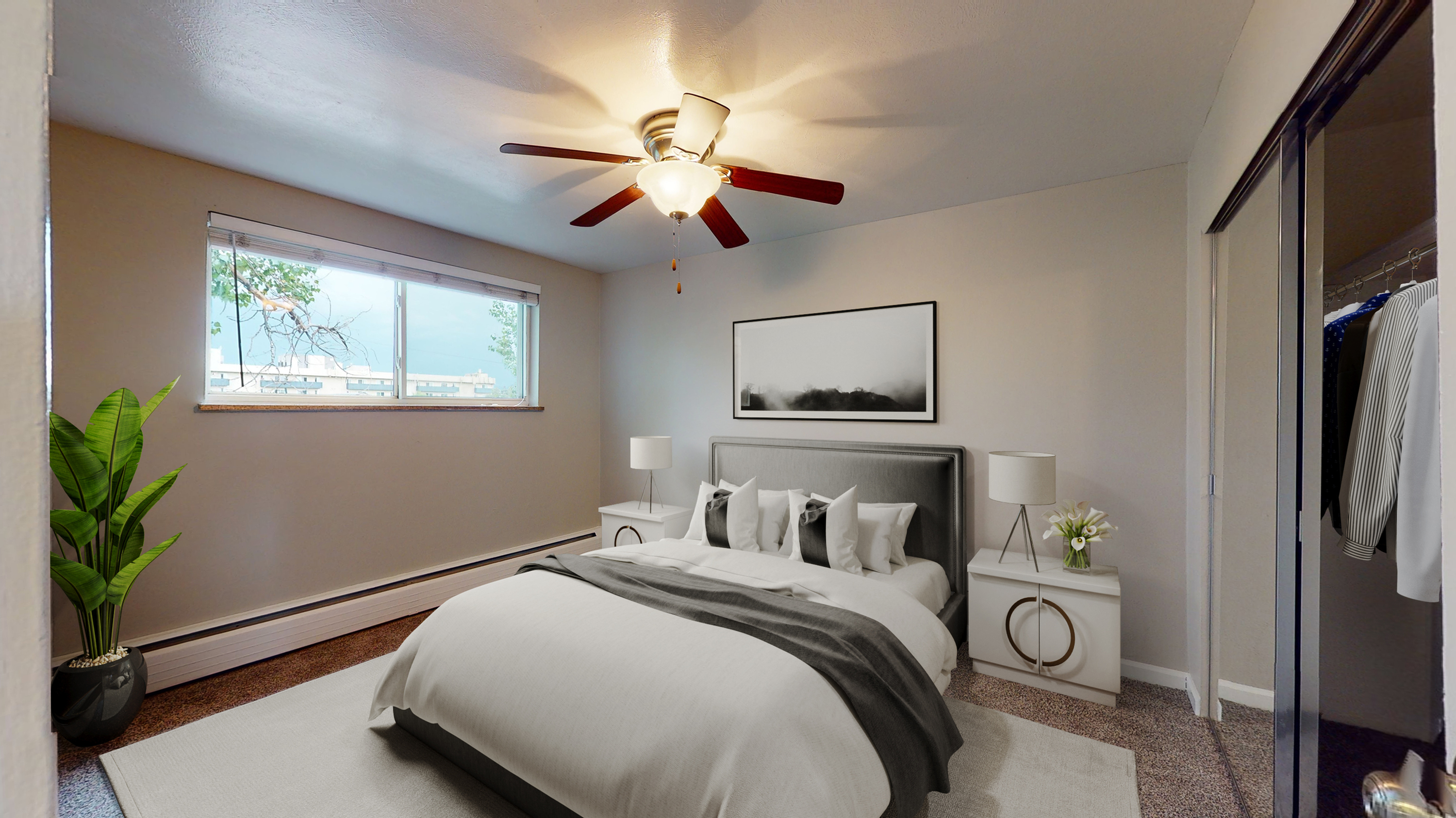 Inviting bedroom with elegant decor featuring a plush bed, modern ceiling fan, and ample natural light.