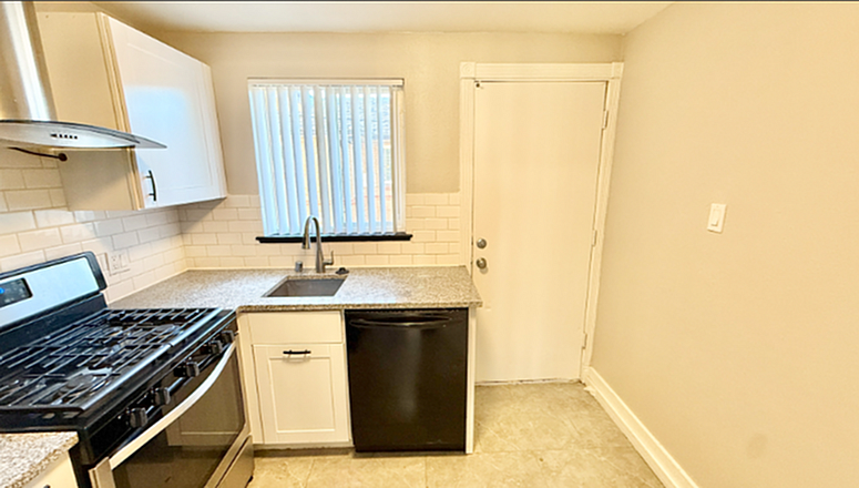 Bright and modern kitchen featuring sleek countertops, stainless steel appliances, and elegant tile flooring.
