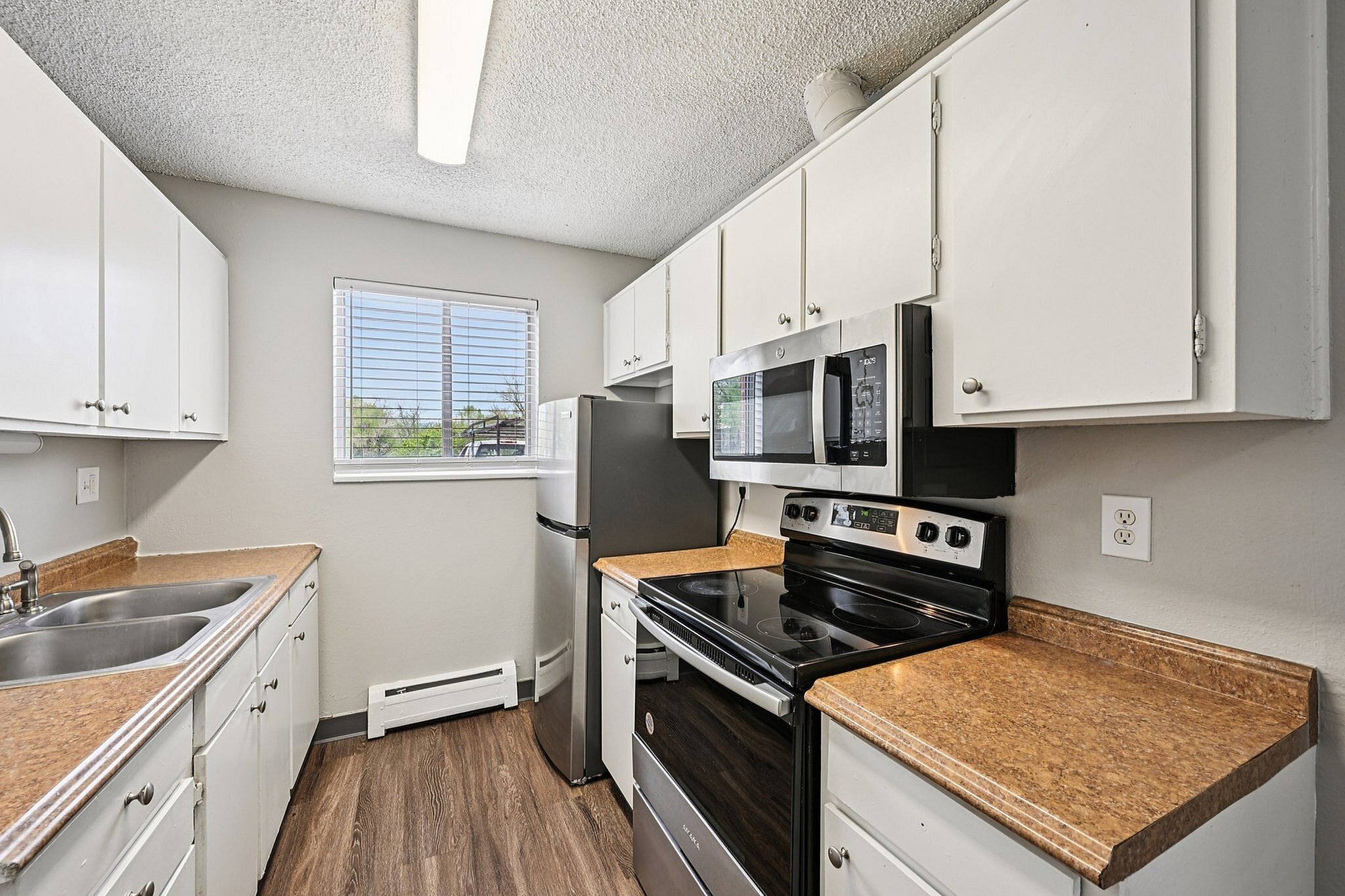 Bright and inviting kitchen with modern appliances, sleek countertops, and ample cabinet space, perfect for culinary enthusiasts.
