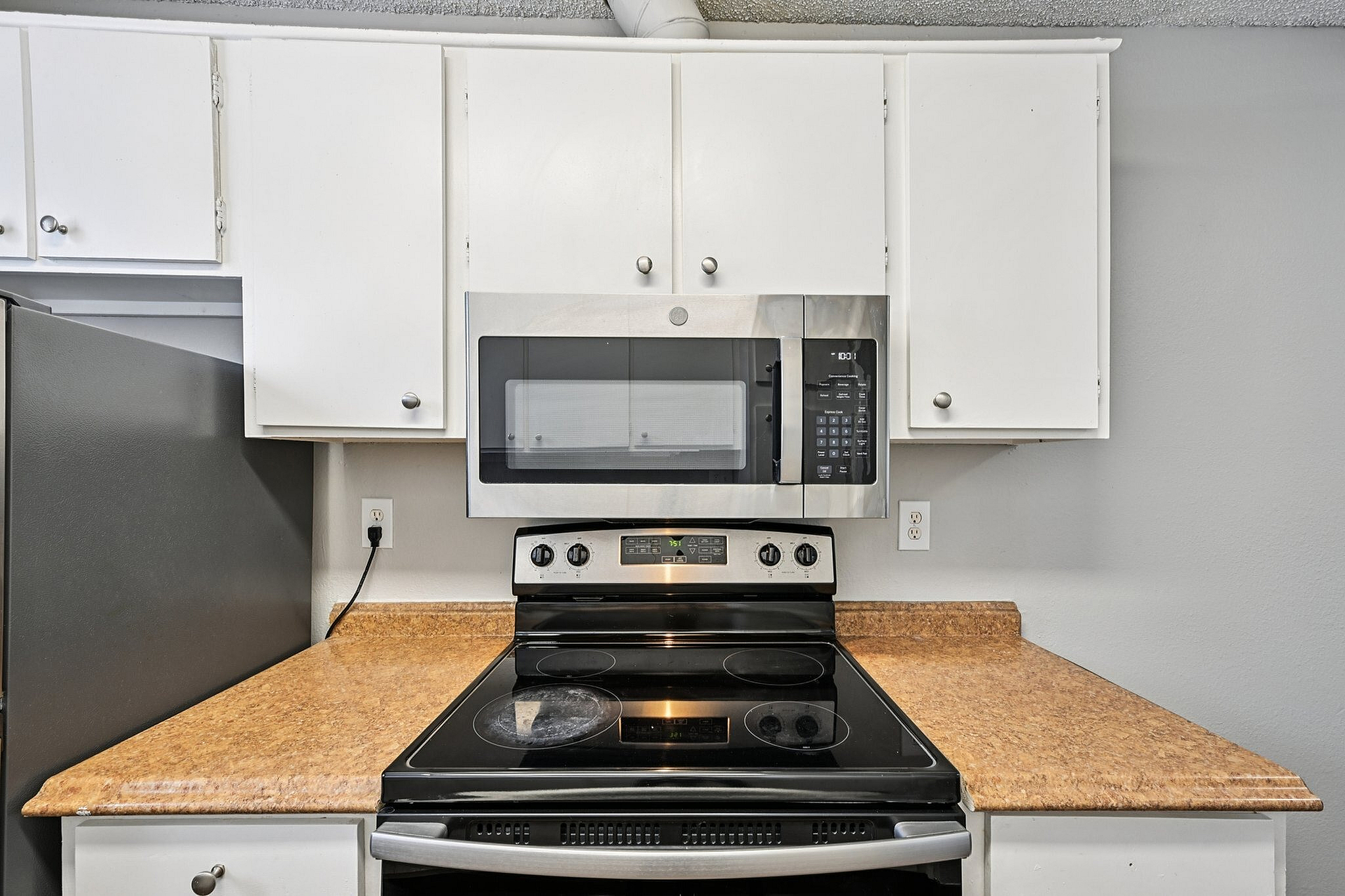 Modern kitchen with sleek stainless steel appliances and stylish wooden countertops.