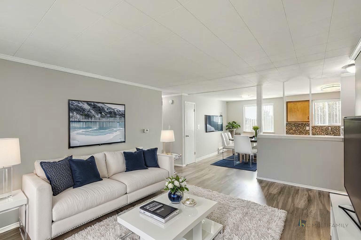 Bright and welcoming open-concept living room and dining area with stylish decor and natural light.