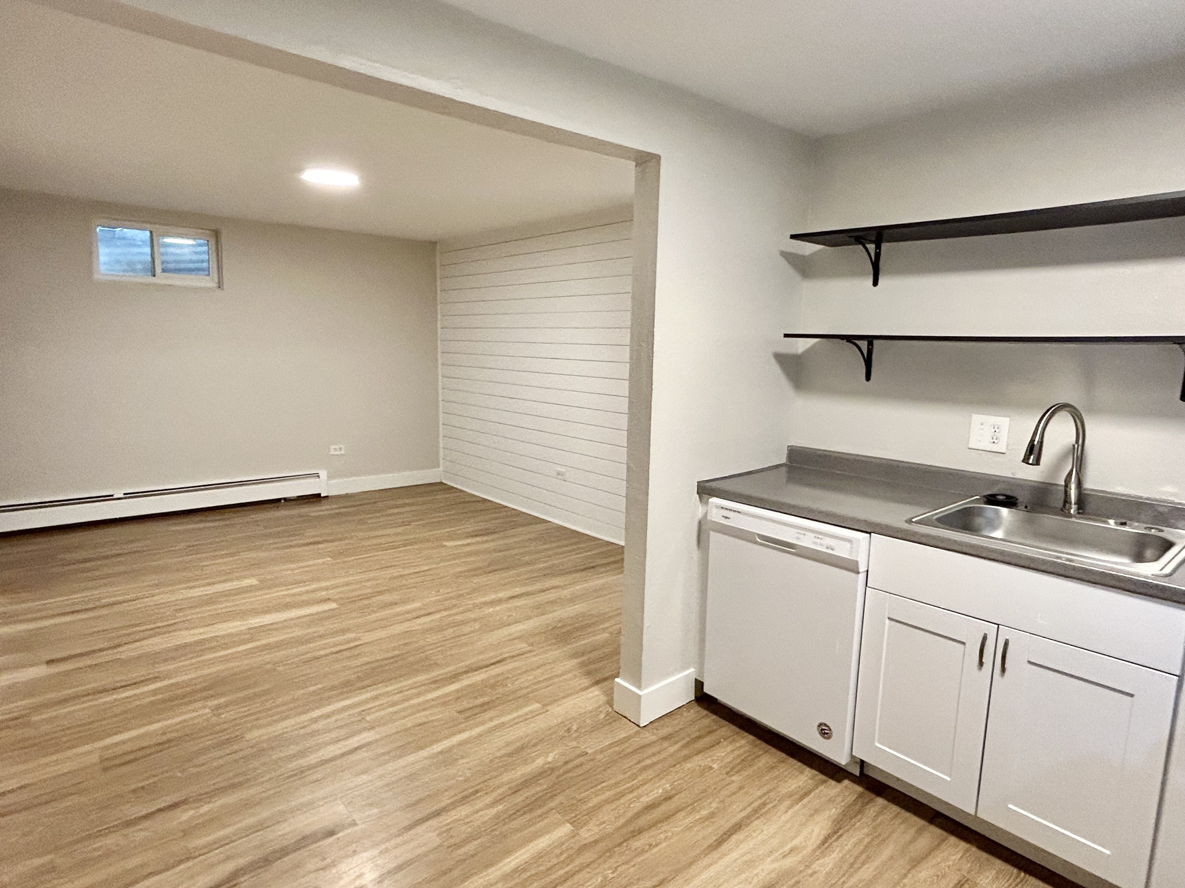 Bright and inviting open-concept space with modern kitchen amenities, sleek hardwood floors, and ample natural light.
