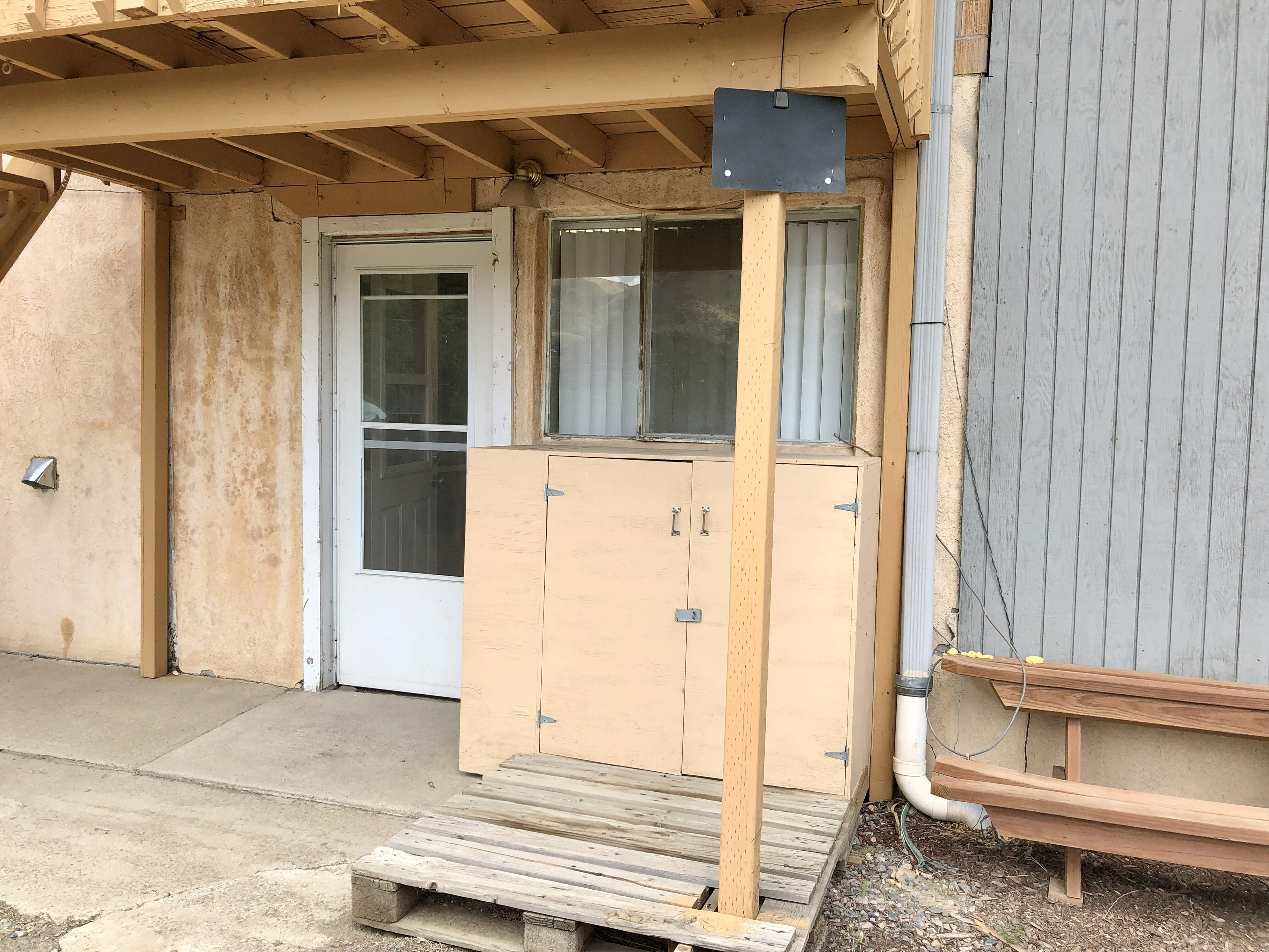 Inviting apartment entrance featuring a white door with glass panels under a covered porch.