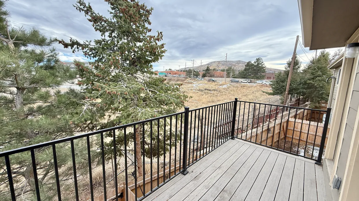 Charming balcony with scenic views of lush greenery, perfect for relaxing outdoors.