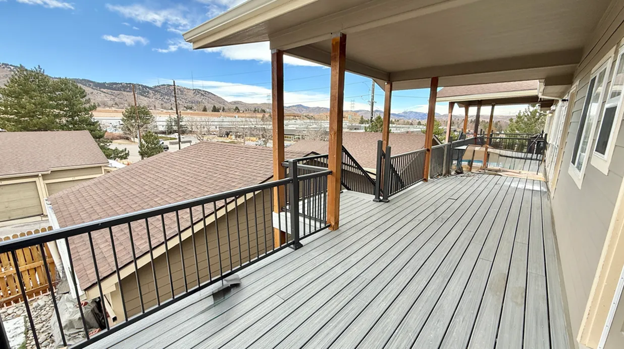 Expansive wooden balcony with scenic mountain views, perfect for relaxation and outdoor entertaining.