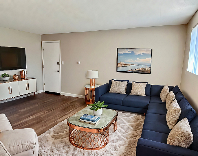 Stylish living room with a navy sectional, modern decor, and a cozy atmosphere.