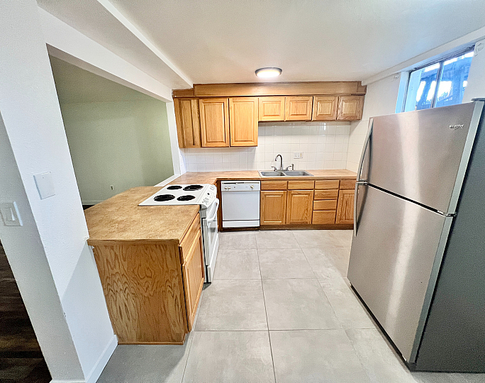 Charming kitchen with modern appliances, sleek countertops, and abundant natural light.