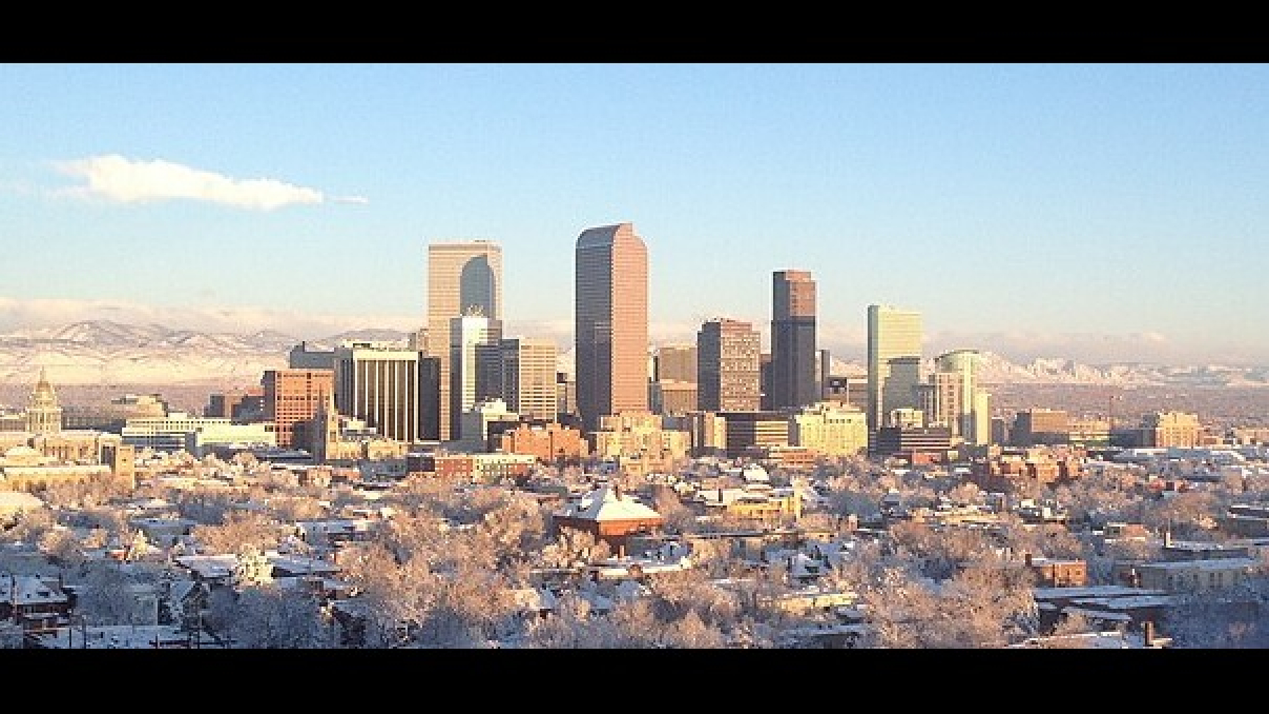 Breathtaking winter skyline of Denver with majestic mountains in the background, perfect urban retreat.