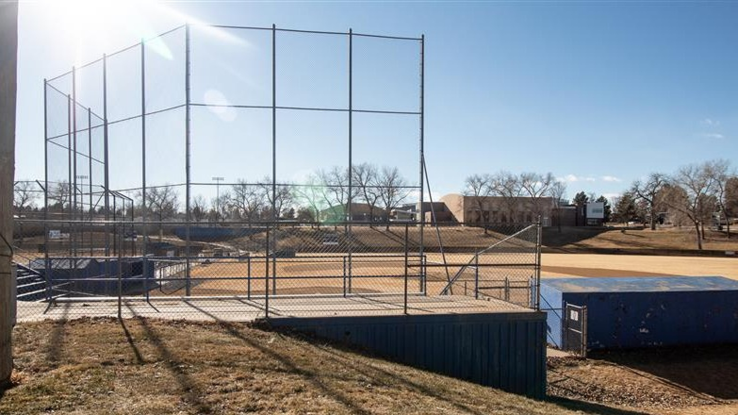 Inviting baseball field with a sunlit backdrop, perfect for community games and outdoor activities.