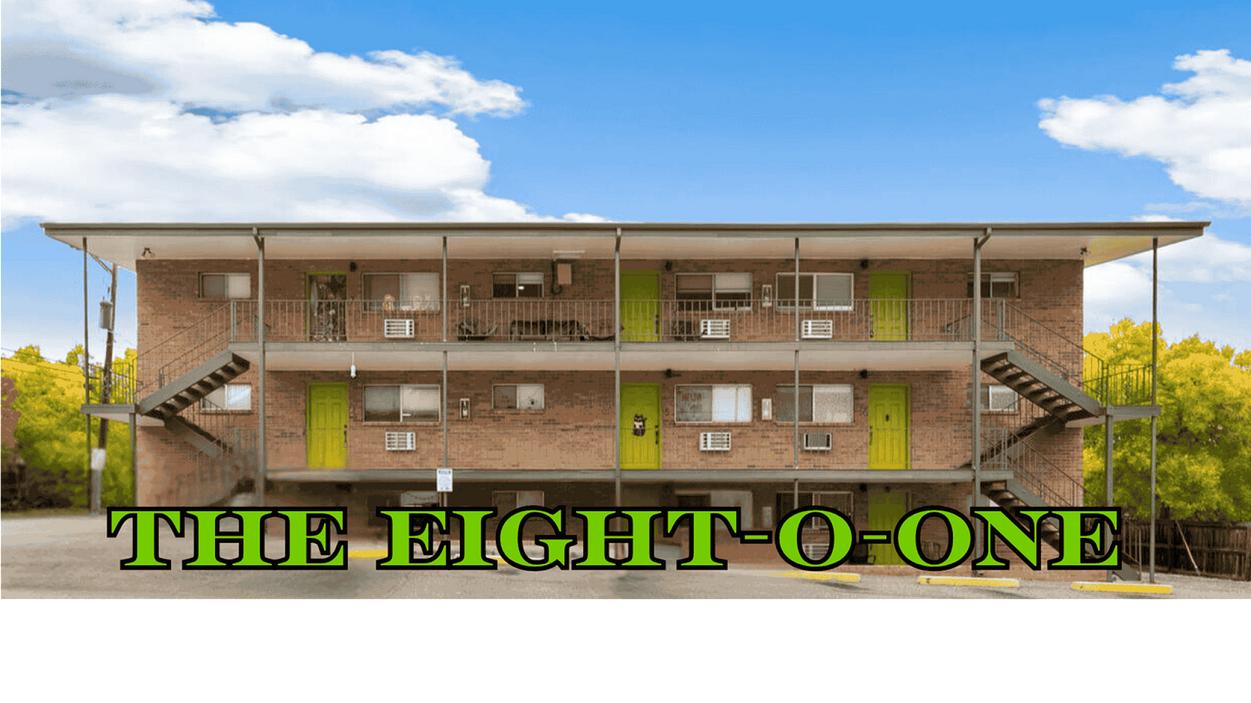 Charming apartment complex with vibrant green doors under a clear blue sky, inviting and trendy living space.