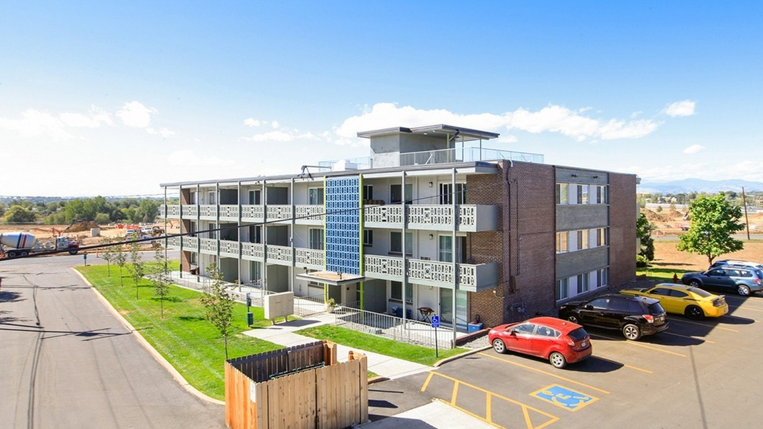 Contemporary apartment building with spacious balconies, ample parking, and scenic views of nature. Ideal for modern living.