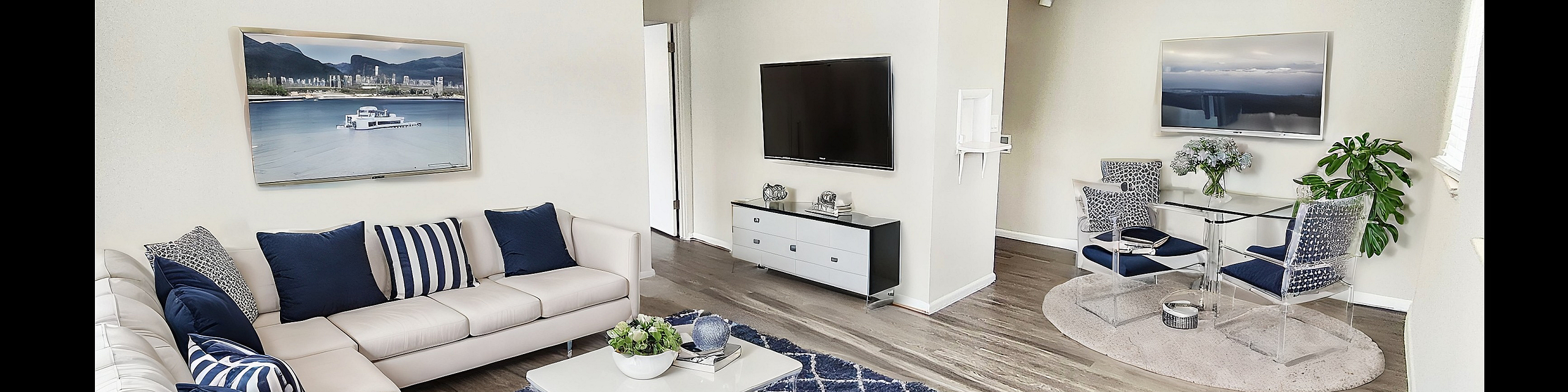 Bright and modern living room with elegant white sofas, stylish decor, and a cozy dining area, enhanced by natural light and chic hardwood floors.