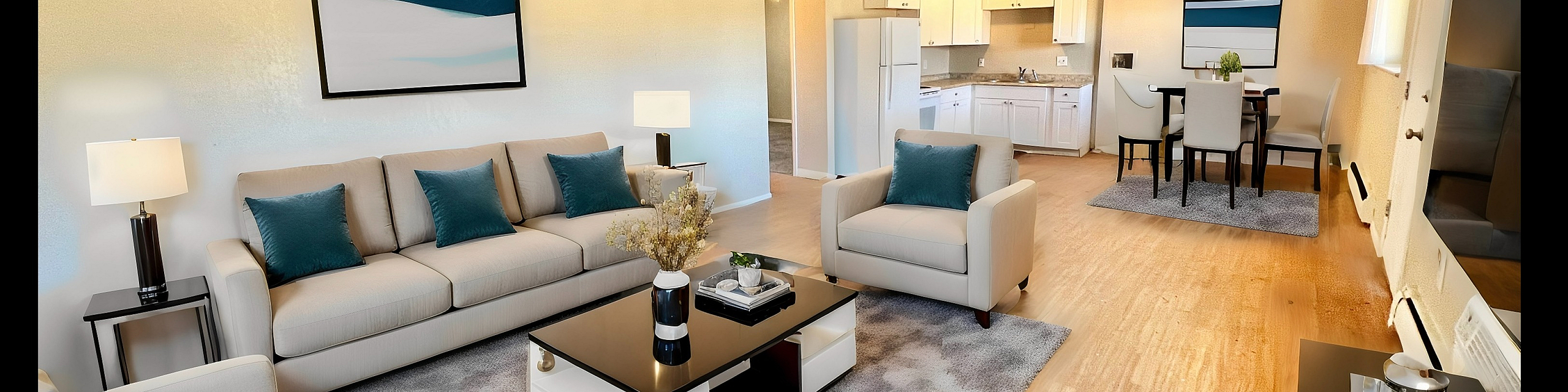 Inviting open-concept living room with plush seating, elegant decor, and a modern dining area seamlessly leading to a bright kitchen.