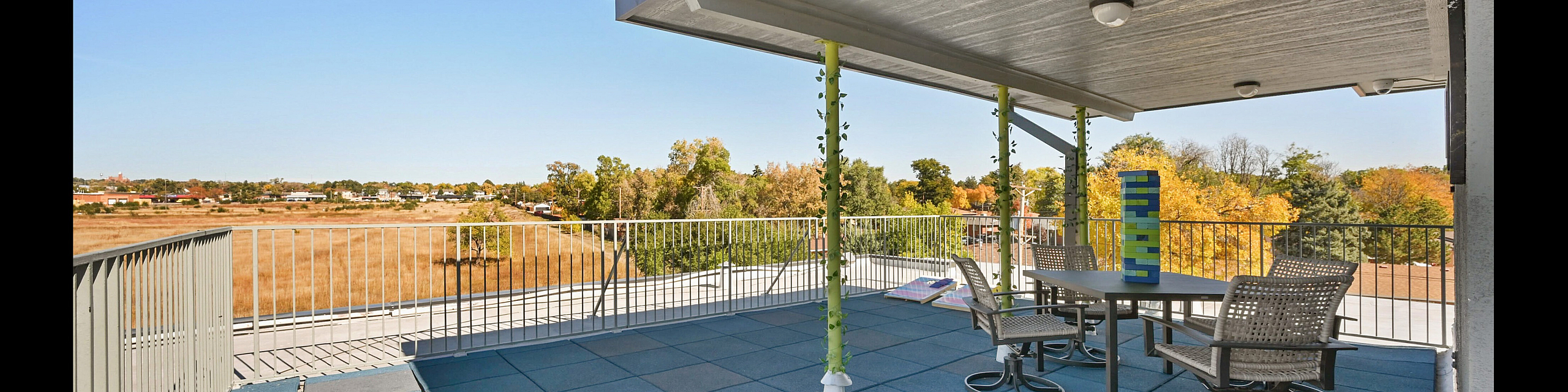 Expansive rooftop terrace featuring modern seating and panoramic views over a serene landscape, perfect for relaxation and entertaining.
