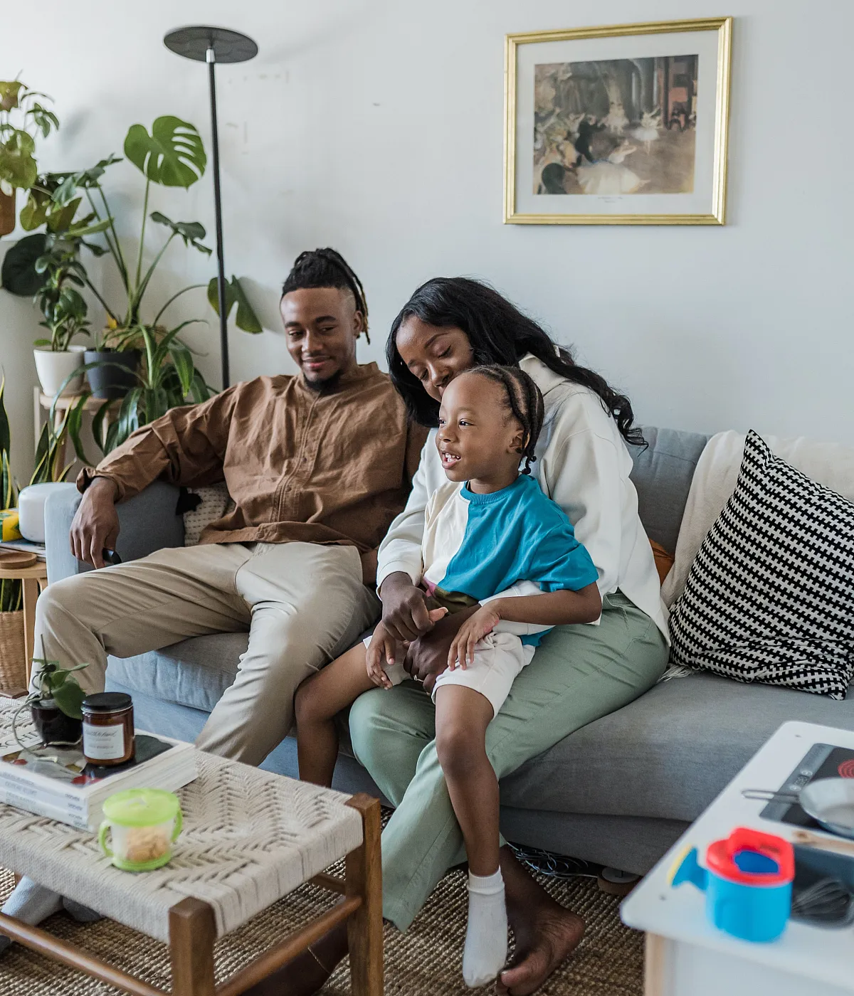 Cozy family living room with stylish decor, lush green plants, and a warm, inviting atmosphere.