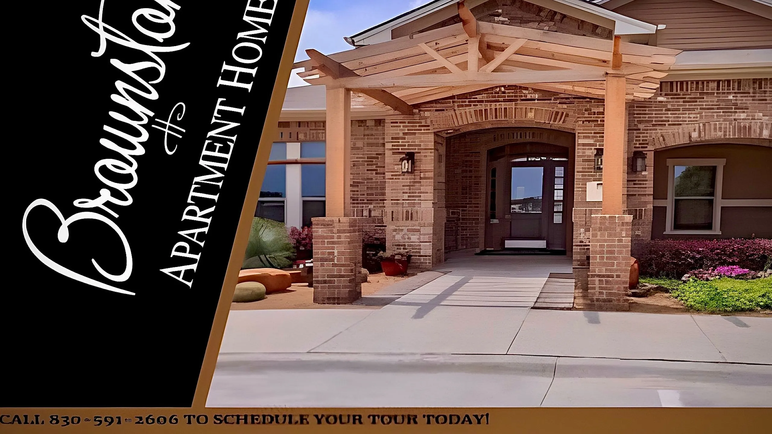 Elegant entrance of Brownstone Apartment Homes with beautiful brickwork and a welcoming outdoor seating area.