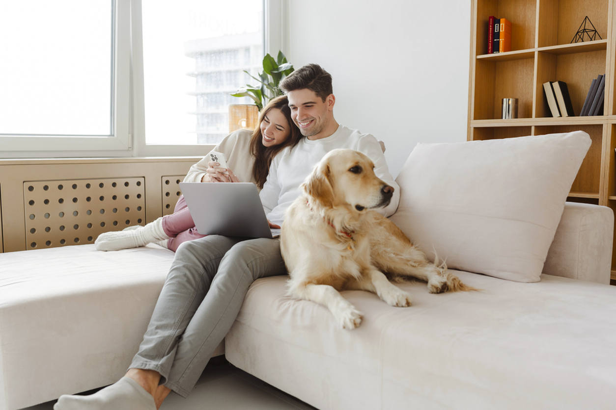 family with dog on couch