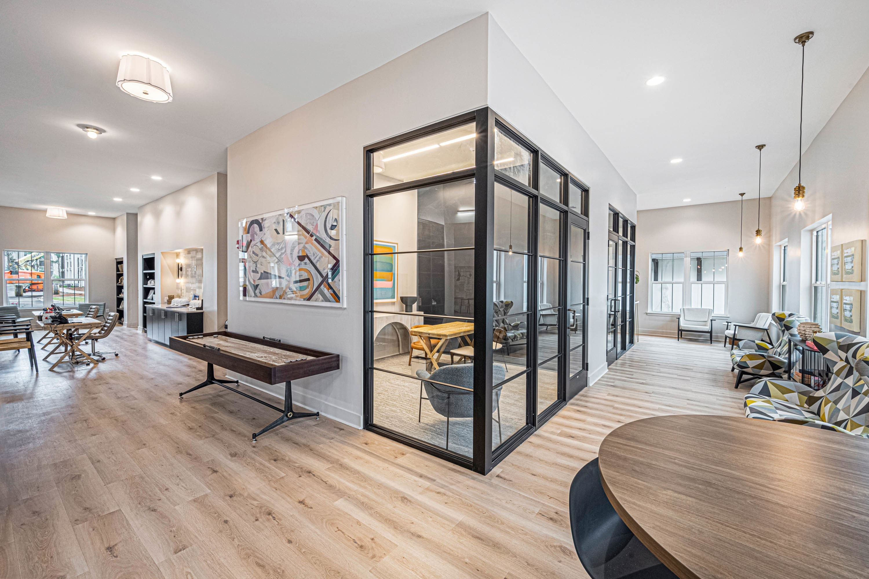 Furnished clubroom with shuffleboard table and conference room