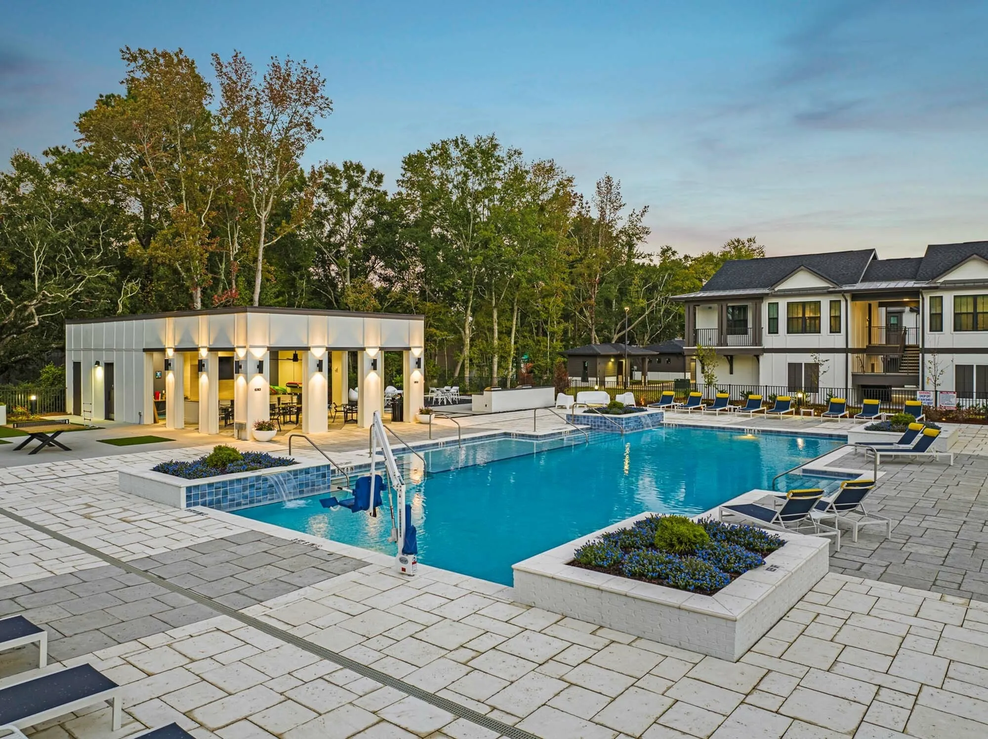 Outdoor pool with covered patio and view of exterior of community