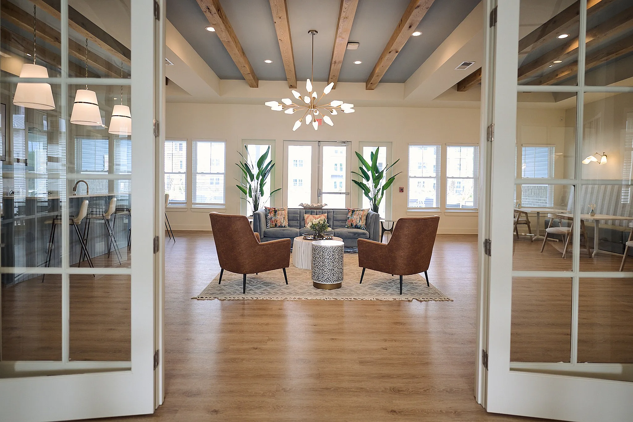 Stylish open lounge with elegant seating, modern lighting, and large windows.