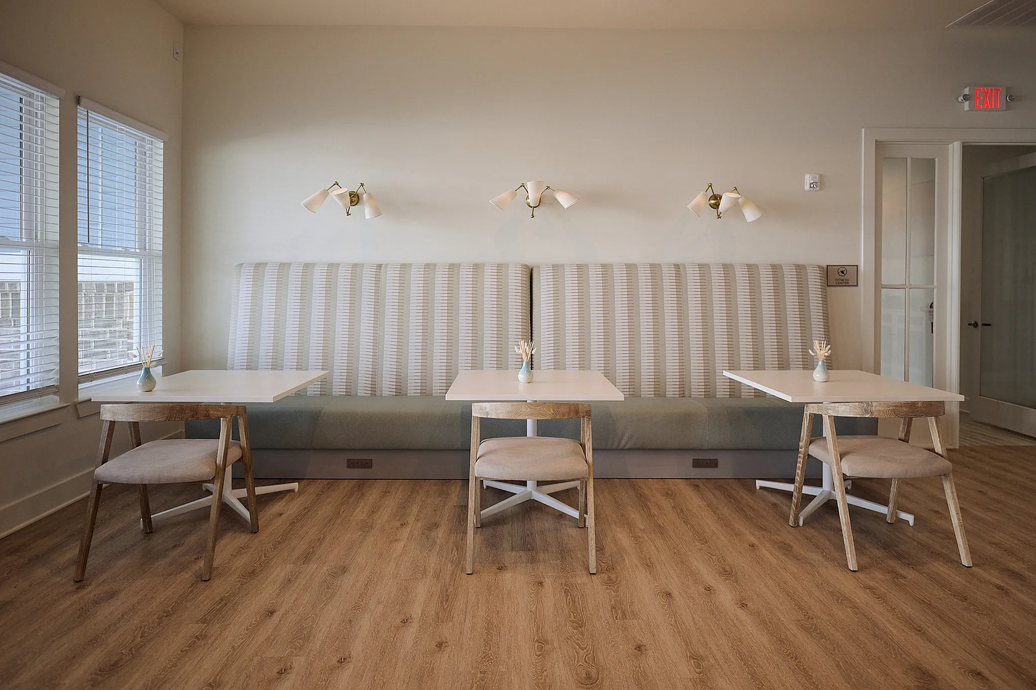 Stylish dining area with modern seating, wooden floors, and ambient lighting.