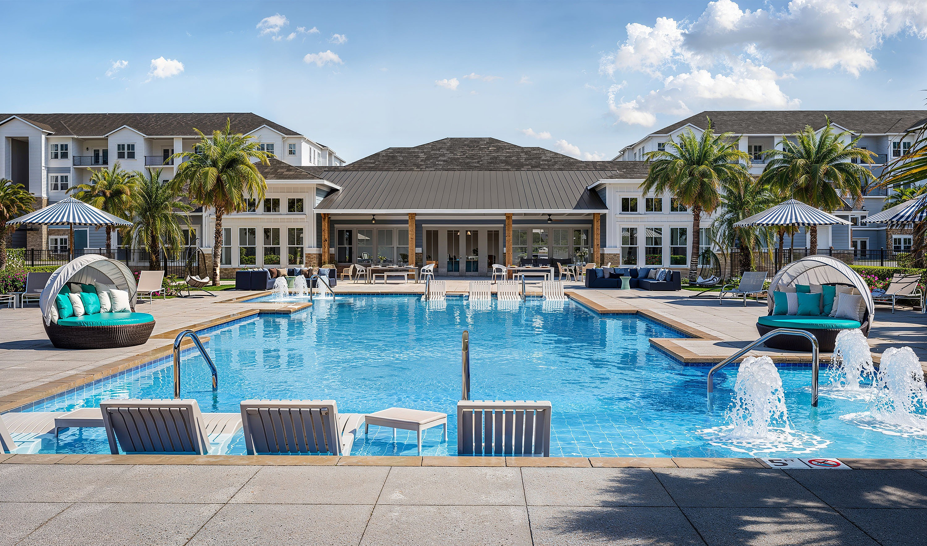 Inviting luxury apartment pool area with modern sun loungers and vibrant palms.
